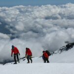 tourist walking on top of mount Kilimanjaro